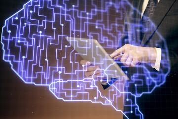 Double exposure of man's hand holding and using a digital device and brain hologram drawing. Data concept.