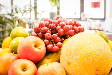A bowl of fruit sits on a table in an apartment.
