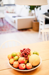 Obraz na płótnie Canvas A bowl of fruit sits on a table in an apartment.