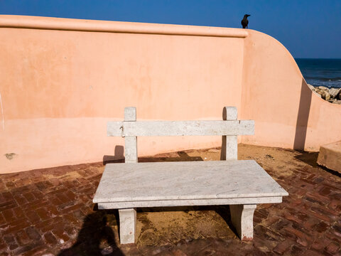 A vintage stone bench for tourists at the seaside fort in the old Danish colony of Tranquebar.