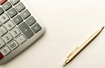 Calculator and ballpoint pen close-up.