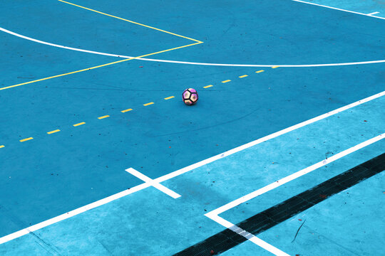 an empty training field with a soccer ball