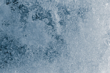 Fototapeta na wymiar Crunchy ice texture crystal blue tone background. The textured cold frosty surface of the ice.