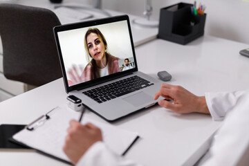 Woman talking with doctor by video call 