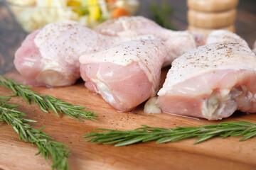  raw chicken drumstick on a chopping board 