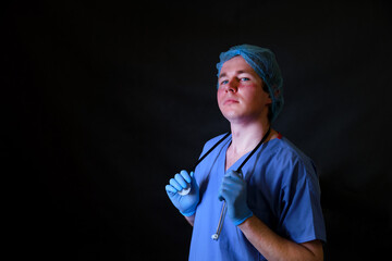 Doctor with mark of a mask on his face, dark background copy space