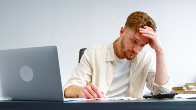 Concentrated and worried manager looks at paper checks