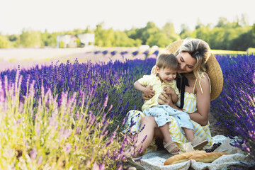 Beautiful woman and her cute little son in the lavender field