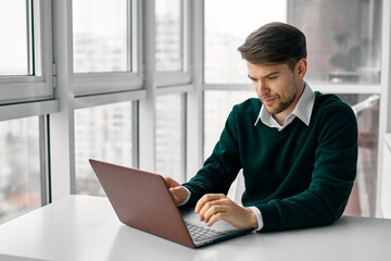 business man typing text on laptop indoors office interior model