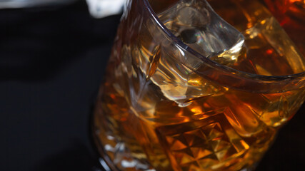 whiskey with ice in glasses close-up, strong alcohol