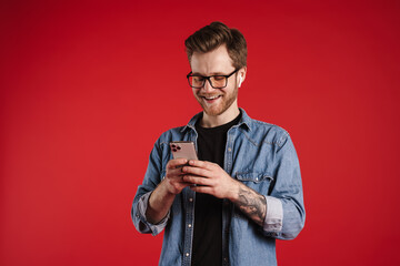 Happy smiling young man in casual clothes standing