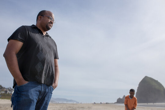 Low angle of father and son on Cannon Beach