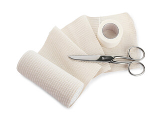 Medical bandage roll, sticking plaster and scissors on white background, above view