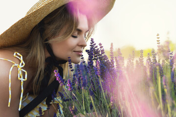 Beautiful young woman in a field full of lavender flowers