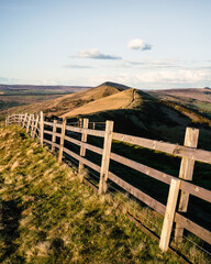 a close up of a hillside next to a wooden fence - Mam tor