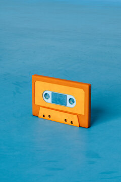 Orange musicassette on blue background