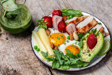 Keto, ketogenic diet, Fried egg, avocado, strawberry, grilled chicken fillet, cheese, nuts and arugula. low carb, high good fat, healthy food