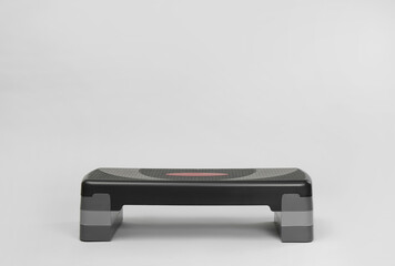 Step platform on light background, space for text. Sport equipment