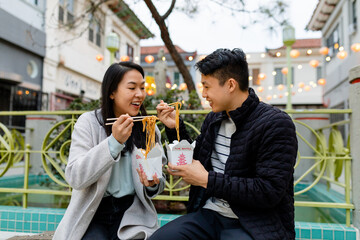 Stock Photo of an Asian Couple Eating Chinese Takeout Food
