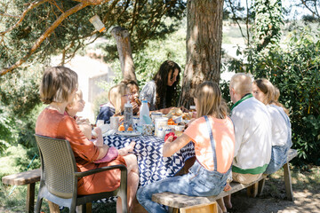 family enjoying a meal outdoors 
