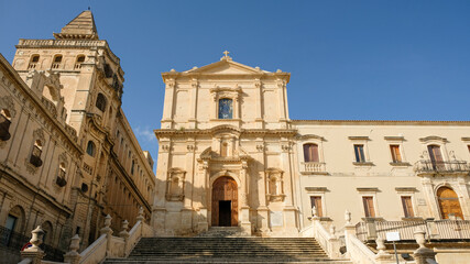 Fototapeta na wymiar Noto, Sicily. Church of Saint Francis of Assisi to the Immaculate at center. To the left, the building of Seminario Vescovile.