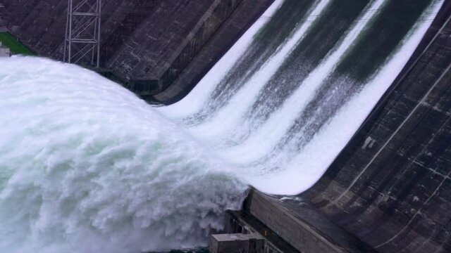 Huge wave close-up, water flow. waterfall, Hydroelectric power. ecology and water splashes draining through a dam in Krasnoyarsk Russia of excess water from the reservoir. Wave for windsurfing