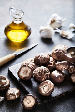 Shiitake Mushrooms on Cutting Board with Olive Oil and Garlic 