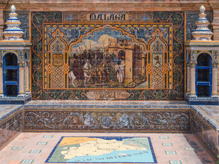 bench in the plaza españa in seville, representing historical events in Malaga in Pisan tiles and with two towers of shelves on the sides.