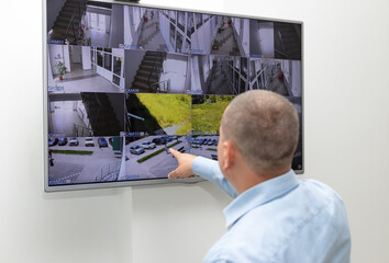 security guard monitoring surveillance security system on large CCTV monitor. Surveillance, modern...