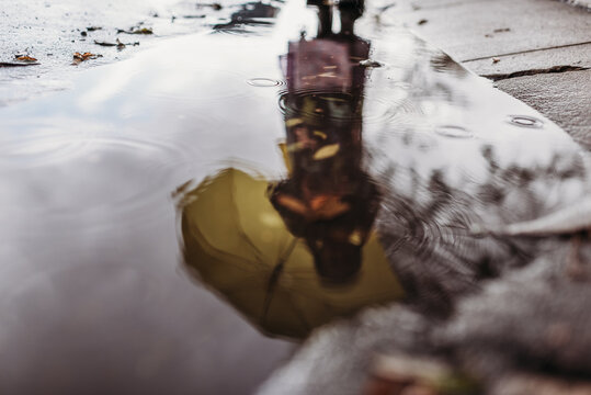 Reflection of girl in puddle