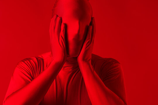 Crazy Screaming Red Man On A Red Background. Figure In A Leotard