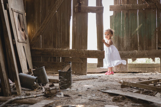 Toddler in rustic abandoned barn