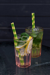 Different types of mojito cocktail on cafe background.