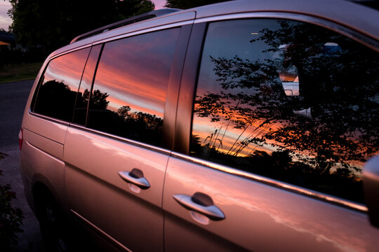 Sunset reflecting off side of minivan