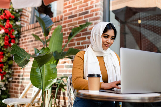 Muslim Woman Works on Laptop