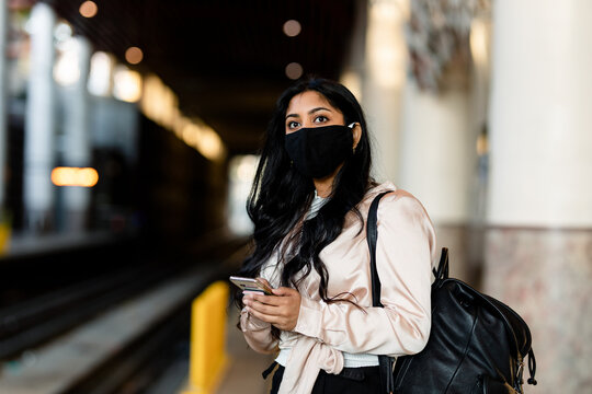 Woman Wearing Mask Waits for Train