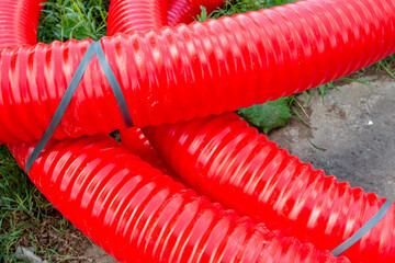 The red pipe is prepared for the replacement of the water supply. Replacement of the city pipeline.