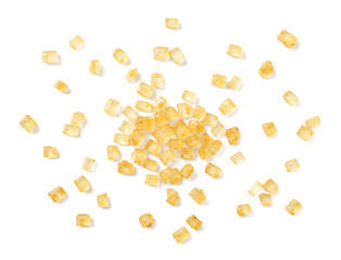 close up of yellow sanding sugar isolated on white