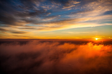 Sunset above the clouds captured from a motorized paraglider
