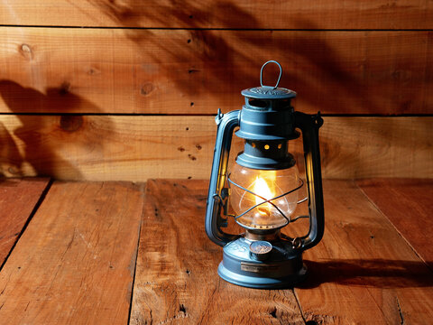 vintage kerosene oil lantern lamp burning wood floor