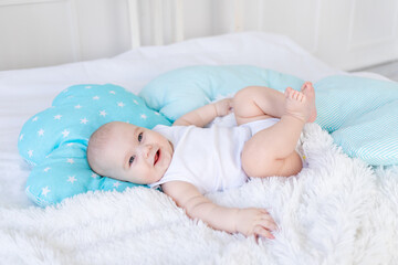 baby boy lying in bed before going to bed, cute, laughing, six-month-old, smiling little baby