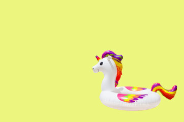 inflatable circle or ring for kids rainbow unicorn for floating in summer vacation isolated on colored background