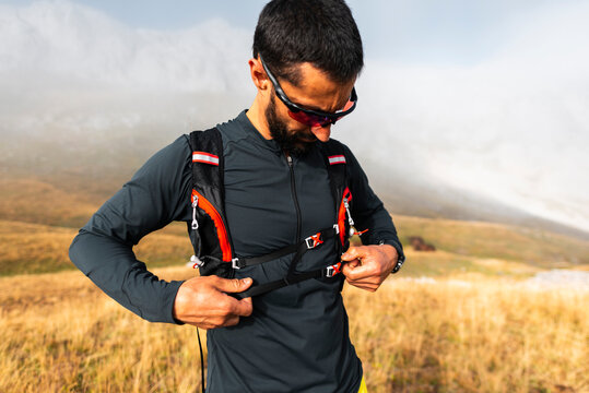 Adult male athlete wearing runner backpack