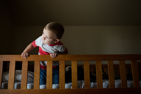 Boy peeks over edge of bunkbed rail