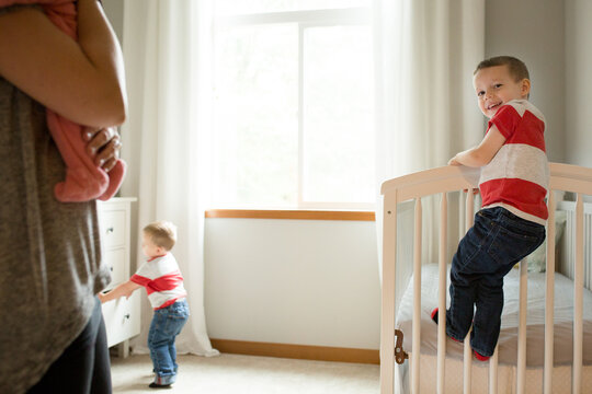 Boys climb on nursery furniture 