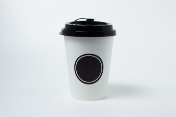 Paper coffee cup with lid on a white background. There is a place for an inscription or a logo. Coffee to go