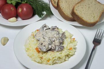 Pilaf with mushroom gravy in a creamy sauce. Delicious and healthy food. Vegetarian dish.
