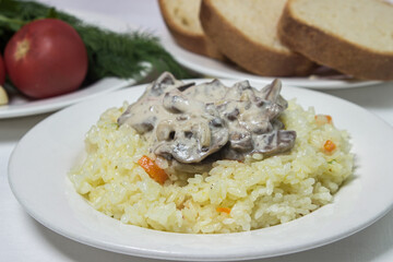 Pilaf with mushroom gravy in a creamy sauce. Delicious and healthy food. Vegetarian dish.