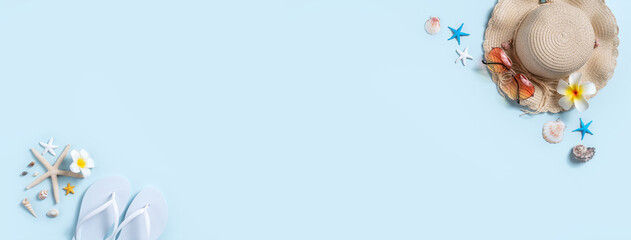 Summer beach background design concept with shells, hat, slipper on blue background.