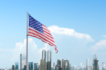 American flag waving in the air with a blue sky background